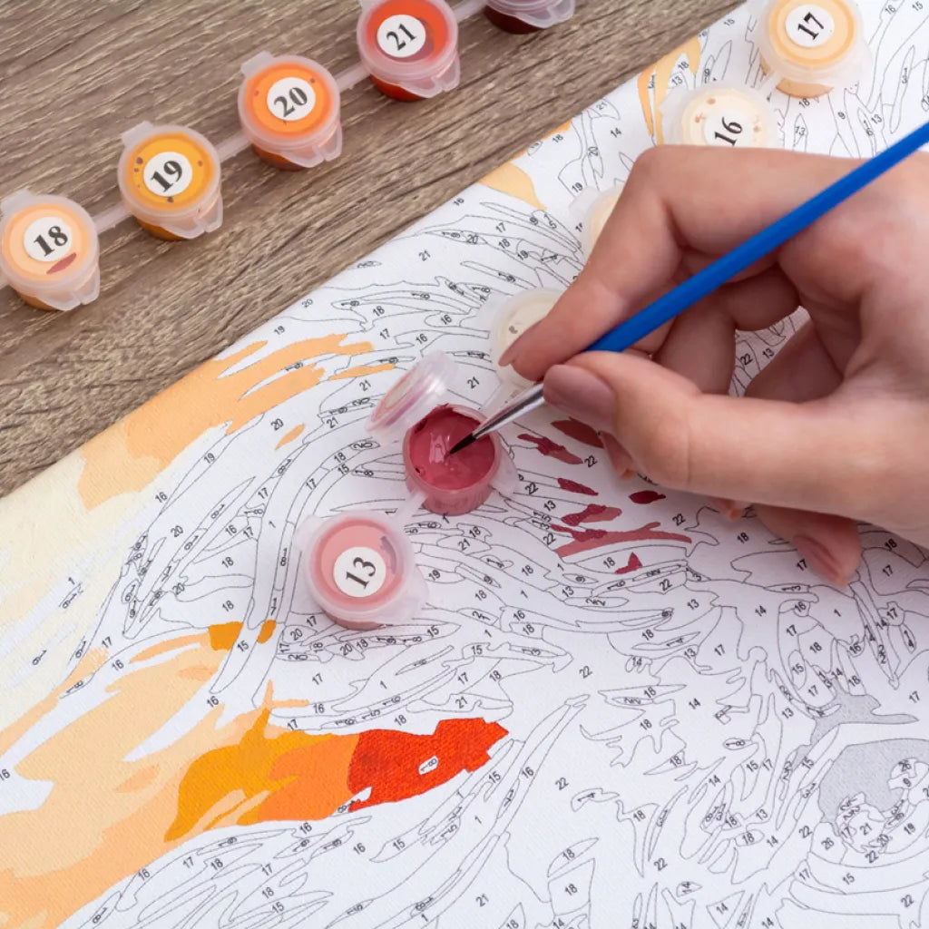 Filling a numbered section of the canvas with matching acrylic paint